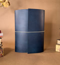 Large desk sized blue leather journal  on a brown background